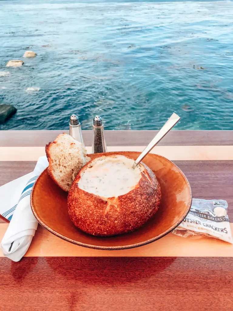 Clam chowder in a bread bowl over the ocean