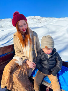 Aubrie and Hughie sitting on sleigh