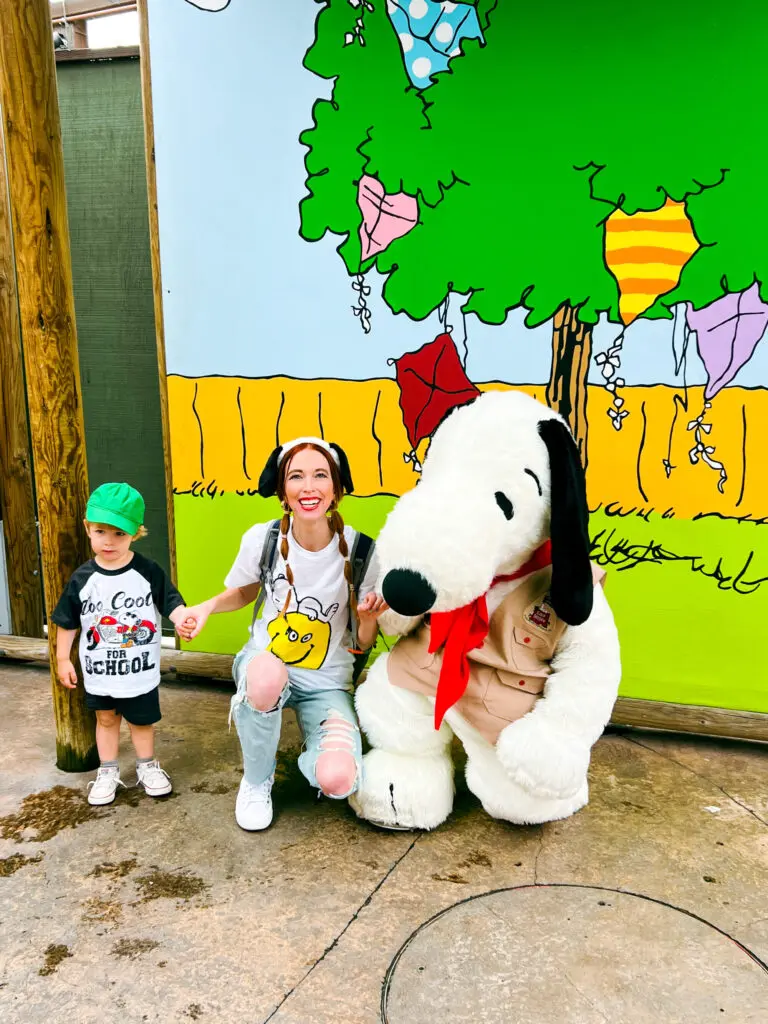 Hughie and Aubrie Taking a picture with Snoopy